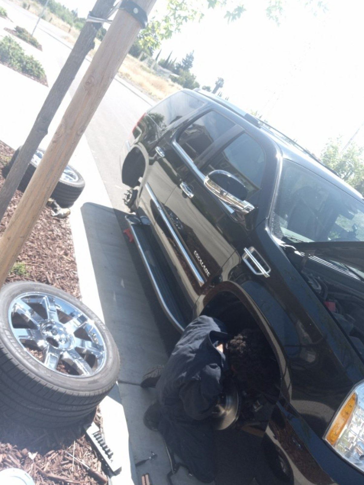 Wheel-off repair on an SUV at a Savannah curb